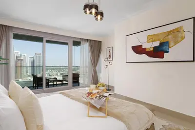 a bedroom with a bed and a large window at Maison Privee - Ultimate Living with Front-Row Views of Burj Khalifa & Dubai Fountains in Dubai