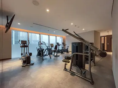 a gym with treadmills and exercise equipment in a building at Maison Privee - Ultimate Living with Front-Row Views of Burj Khalifa & Dubai Fountains in Dubai