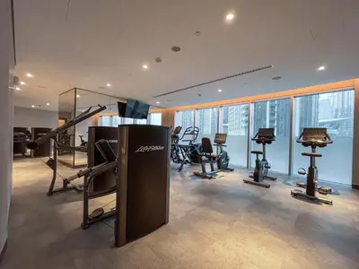a gym with treadmills and exercise equipment in a building at Maison Privee - Ultimate Living with Front-Row Views of Burj Khalifa & Dubai Fountains in Dubai