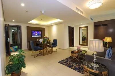 a living room with a couch and a table at Omega Hotel Dubai in Dubai