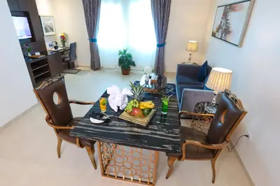 a living room with a table with fruit on it at Omega Hotel Dubai in Dubai