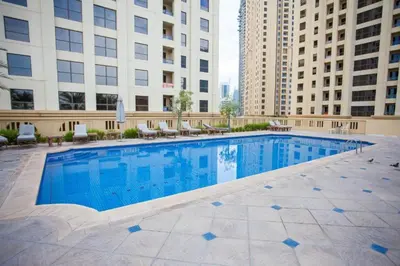 a swimming pool in the middle of a building with buildings at Maison Privee - Premium Apt in the Heart of JBR Beach, Dubai in Dubai