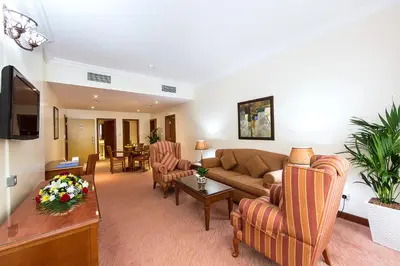 a living room with a couch and a table at Rolla Residence Hotel Apartment in Dubai