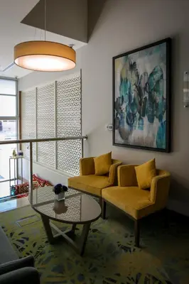 a living room with a couch and a table at MENA Plaza Hotel Albarsha At The Mall in Dubai
