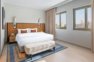 a bedroom with a large bed and a large window at Oaks Ibn Battuta Gate Dubai in Dubai