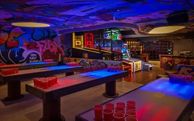 a room with three tables and a game room at Oaks Ibn Battuta Gate Dubai in Dubai