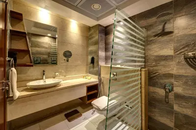 a bathroom with a sink and a glass shower at Rose Park Hotel - Al Barsha, Opposite Metro Station in Dubai