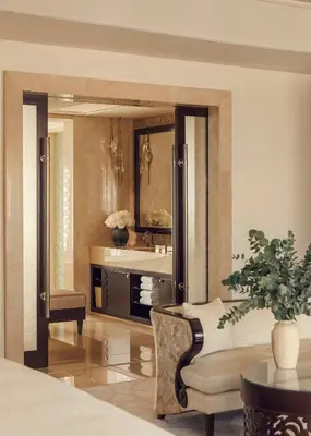 a room with a sink and a chair and a mirror at One&Only The Palm Dubai in Dubai