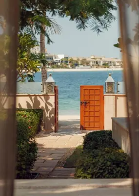an orange door in front of a body of water at One&Only The Palm Dubai in Dubai