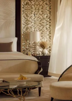 a bedroom with a bed and a table with a bowl of fruit at One&Only The Palm Dubai in Dubai