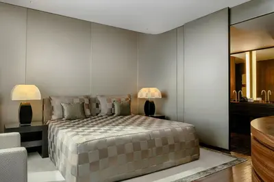 a bedroom with a large bed with two lamps at Armani Hotel Dubai, Burj Khalifa in Dubai