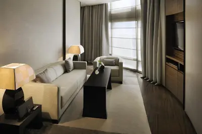 a living room with a couch and a tv at Armani Hotel Dubai, Burj Khalifa in Dubai