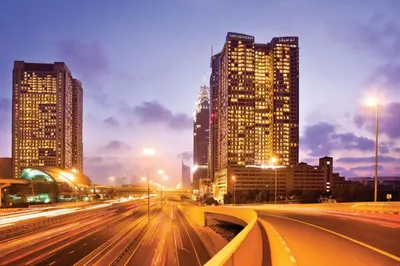 a city at night with tall buildings and street lights at Two Seasons Hotel & Apartments in Dubai