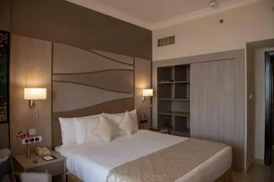 a bedroom with a large bed in a hotel room at Two Seasons Hotel & Apartments in Dubai