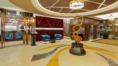 a lobby with a statue in the middle of a room at Park Regis Kris Kin Hotel in Dubai