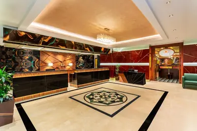 a lobby with a reception desk and a room with a rug at Park Regis Kris Kin Hotel in Dubai