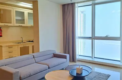 a living room with a couch and a table at Barceló Residences Dubai Marina in Dubai