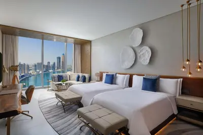 two beds in a hotel room with a view of the city at The St. Regis Downtown Dubai in Dubai