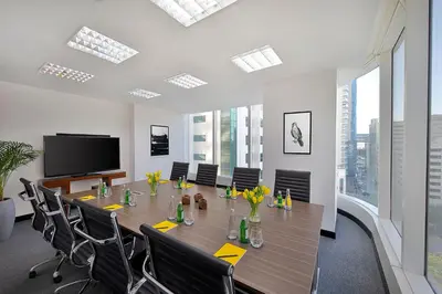 a conference room with a long table and chairs at voco Dubai by IHG in Dubai