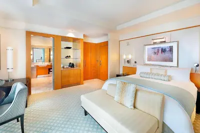 a bedroom with a large bed and a couch at Ritz Carlton DIFC Downtown Dubai in Dubai