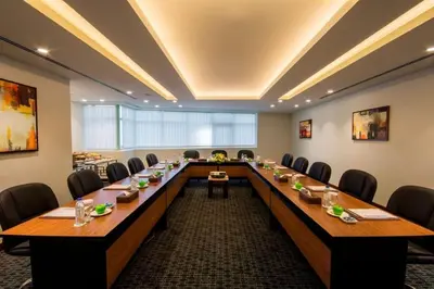 a large conference room with a long table and chairs at Golden Tulip Media Hotel in Dubai