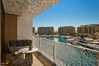 a balcony with a table and chairs and a marina at Bvlgari Resort Dubai in Dubai