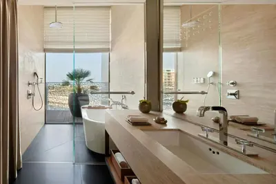 a bathroom with a large sink and a large window at Bvlgari Resort Dubai in Dubai