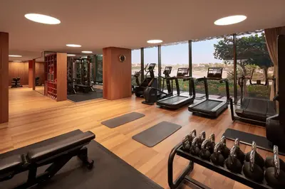 a gym with a lot of treadmills and ellipticals at Bvlgari Resort Dubai in Dubai