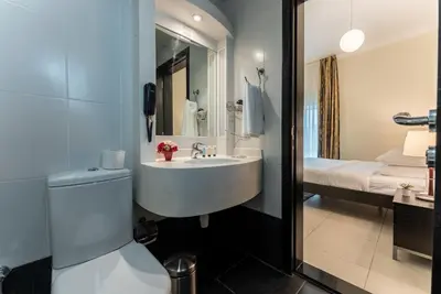 a bathroom with a sink and a bed at Gulf Oasis Hotel Apartments Fz LLC in Dubai
