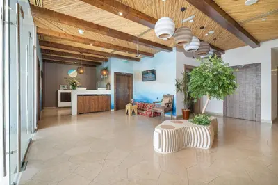 a large living room with a ceiling with wood at Beach Walk Boutique Jumeirah in Dubai