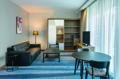 a living room with a couch and a table at Aloft Palm Jumeirah in Dubai