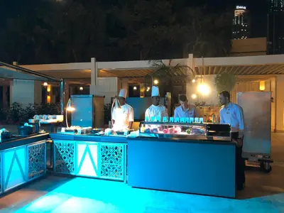 a group of chefs standing in a kitchen at night at Address Dubai Mall Fashion Avenue 1 bedroom 23 floor in Dubai