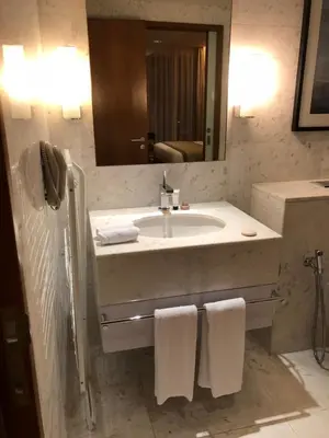 a bathroom with a sink and a mirror and towels at Address Dubai Mall Fashion Avenue 1 bedroom 23 floor in Dubai