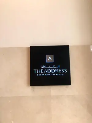 a sign on the wall of the address of a building at Address Dubai Mall Fashion Avenue 1 bedroom 23 floor in Dubai