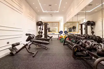 a gym with rows of tread machines in a room at Elite Royal Apartment - Full Burj Khalifa & Fountain view - Opal - 2 bedrooms plus 1 open bedroom without partition in Dubai