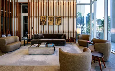 a living room with a couch and chairs and a table at FORM Hotel Al Jaddaf, Dubai, a Member of Design Hotels in Dubai
