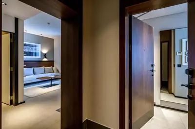a hallway leading to a living room with a couch at FORM Hotel Al Jaddaf, Dubai, a Member of Design Hotels in Dubai