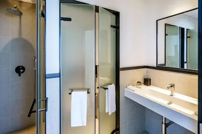 a bathroom with a sink and a mirror at FORM Hotel Al Jaddaf, Dubai, a Member of Design Hotels in Dubai