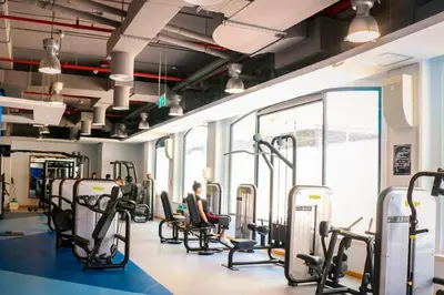 a gym with cardio equipment and people sitting in chairs at Jbr beach walk 2 bedrooms front sea in Dubai