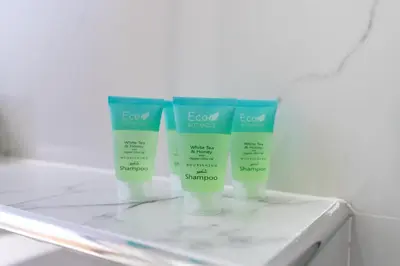 a group of three bottles of sunscreen on a shelf at Jbr beach walk 2 bedrooms front sea in Dubai