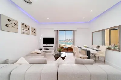 a living room with a couch and a dining room at Jbr beach walk 2 bedrooms front sea in Dubai