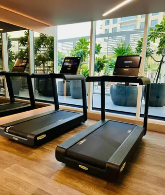 a group of treadmills in a room with a window at Millennium Central Downtown - Dubai in Dubai