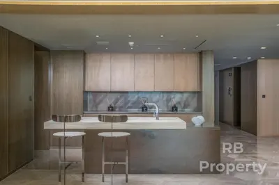 a kitchen with a sink and two bar stools at FIVE Palm Beach Villa -Private Pool & Roopftop Jacuzzi, 3-Level, by Exclusive Holiday Homes in Dubai