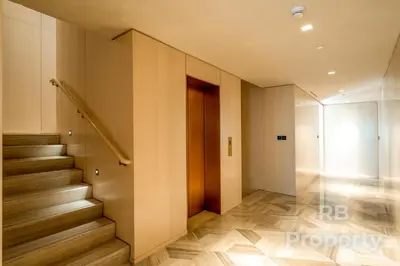 a hallway with a staircase and a stair case at FIVE Palm Beach Villa -Private Pool & Roopftop Jacuzzi, 3-Level, by Exclusive Holiday Homes in Dubai