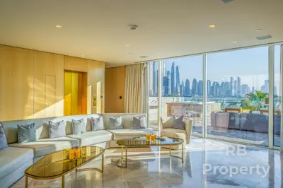 a living room with a couch and a table at FIVE Palm Beach Villa -Private Pool & Roopftop Jacuzzi, 3-Level, by Exclusive Holiday Homes in Dubai
