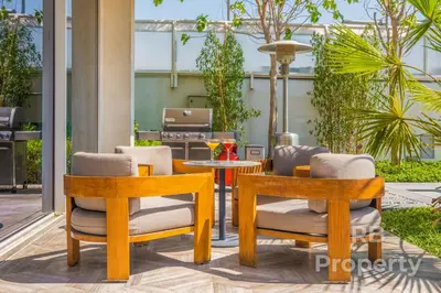 a patio with two chairs and a table at FIVE Palm Beach Villa -Private Pool & Roopftop Jacuzzi, 3-Level, by Exclusive Holiday Homes in Dubai