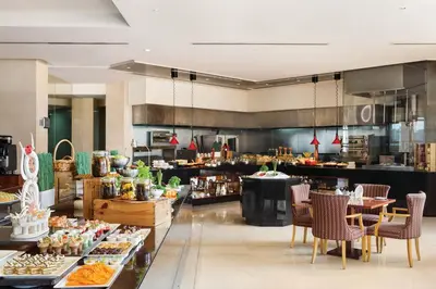a restaurant with a buffet of food on display at Crowne Plaza - Dubai Jumeirah by IHG in Dubai