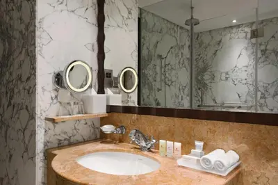 a bathroom with a sink and a large mirror at Crowne Plaza - Dubai Jumeirah by IHG in Dubai