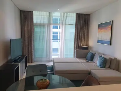 a living room with a couch and a glass table at Dubai Downtown View in Dubai