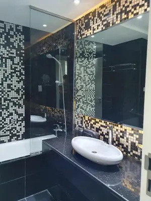 a bathroom with two sinks and a large mirror at Dubai Downtown View in Dubai